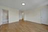 Unfurnished bedroom with light wood-style floors and ensuite bathroom