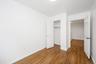 Unfurnished bedroom with dark wood-style flooring and a closet