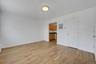 Unfurnished living room with light wood-style floors and baseboards