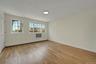 Empty room with light wood-style floors and a baseboard radiator