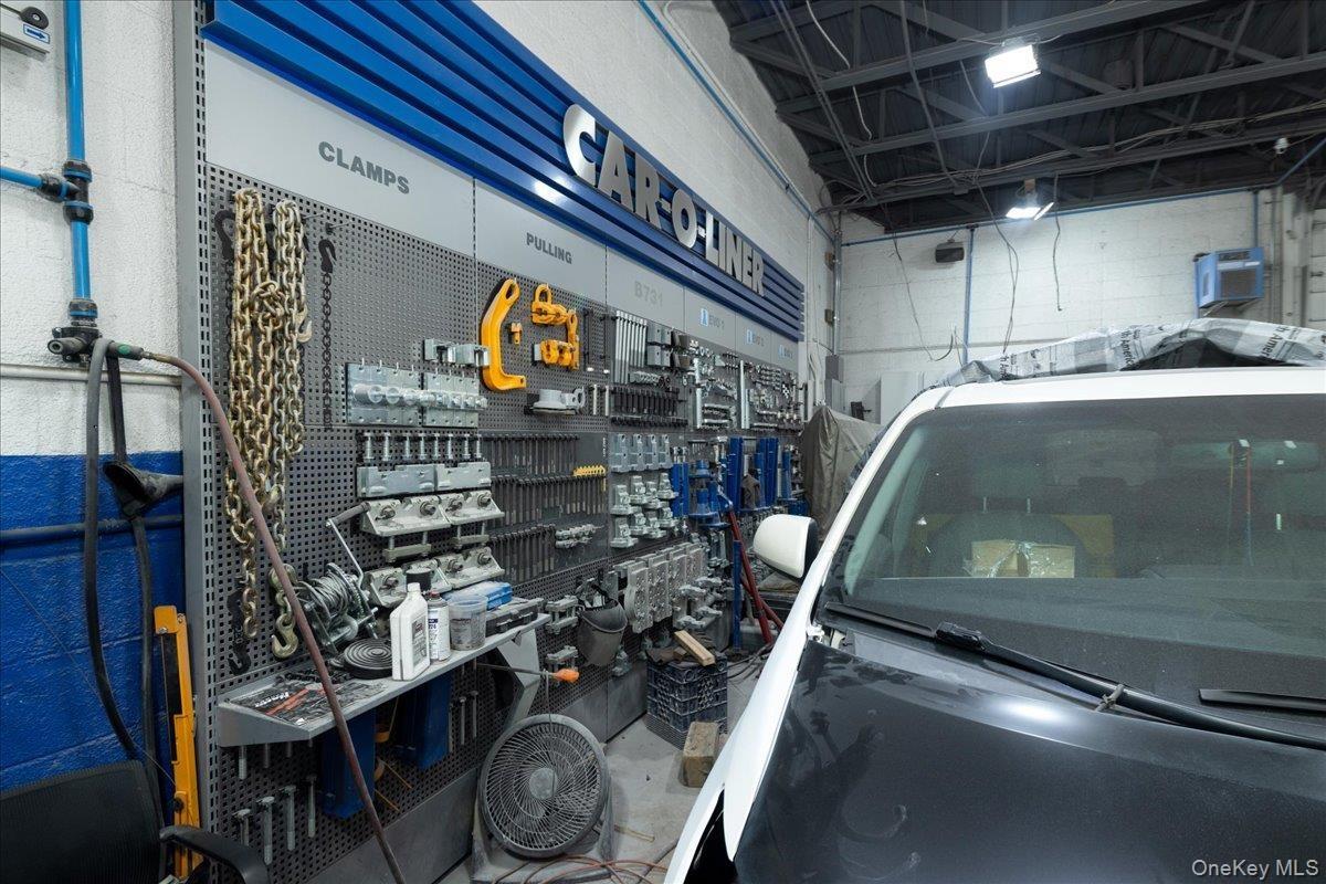 Garage featuring concrete block wall