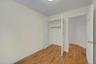 Unfurnished bedroom with light wood-style flooring and a closet