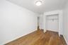 Unfurnished bedroom featuring dark wood finished floors and a closet