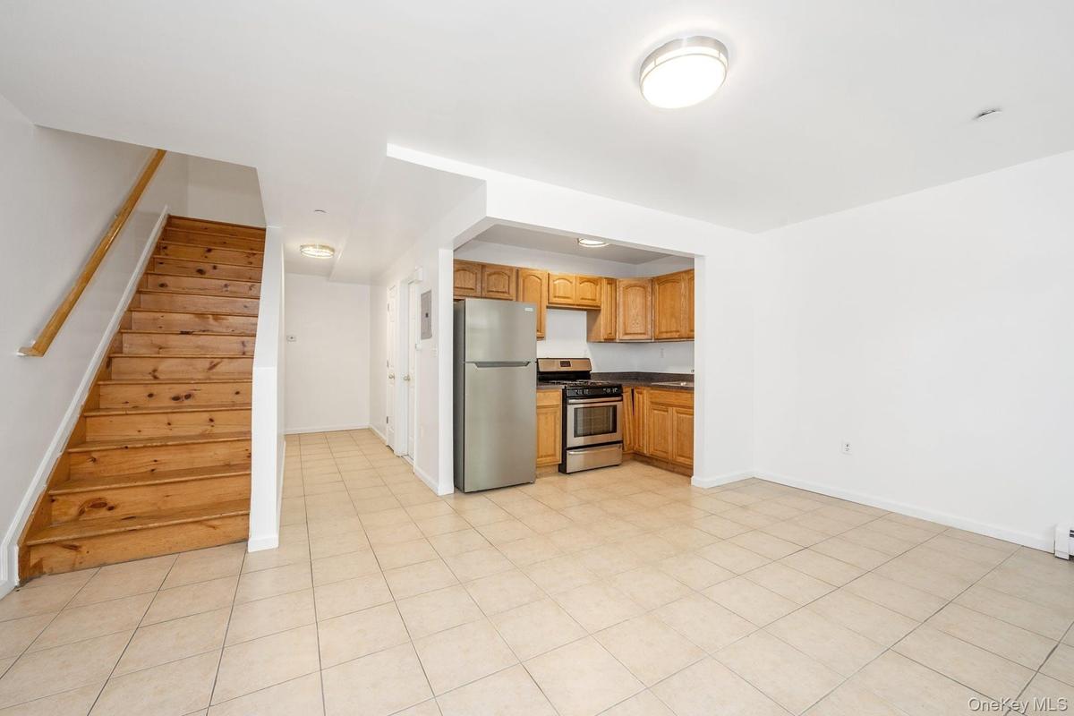 Kitchen with dark countertops and appliances with stainless steel finishes