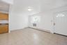 Foyer featuring a baseboard heating unit and light tile patterned flooring