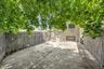 Fenced backyard featuring a patio area and driveway