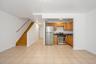 Kitchen with appliances with stainless steel finishes and brown cabinetry