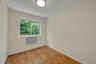 Empty room with a baseboard heating unit and wood-type flooring