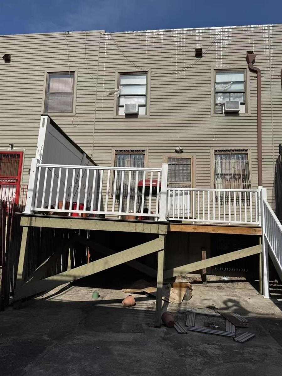 Rear view of property with a wooden deck