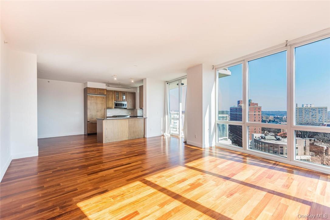 Unfurnished living room with hardwood / wood-style flooring and floor to ceiling windows