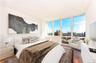 Bedroom featuring a wall of windows and hardwood / wood-style flooring