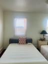 Bedroom featuring multiple windows and ornamental molding