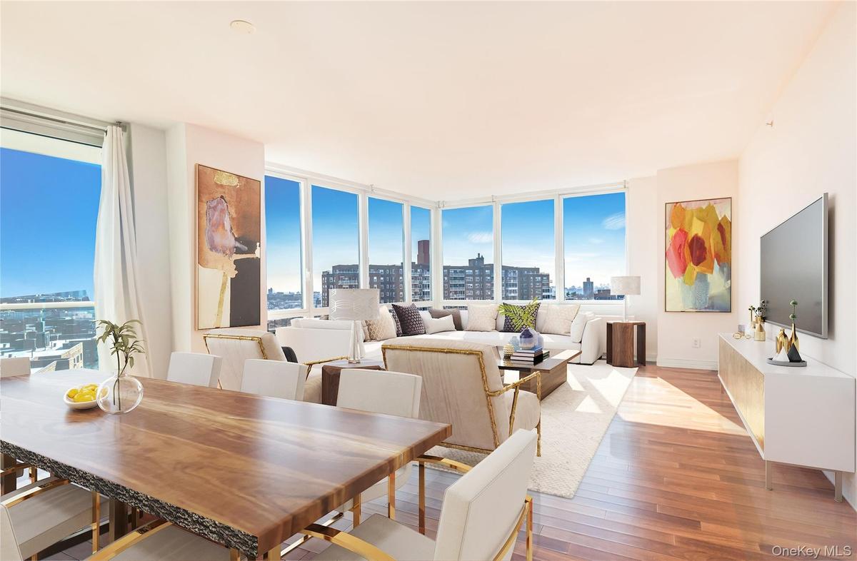 Dining room with a wall of windows, light wood finished floors, and plenty of natural light