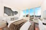 Bedroom featuring dark wood-type flooring and expansive windows