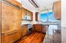 Kitchen featuring dark stone countertops, dark hardwood / wood-style flooring, decorative backsplash, high quality appliances, and sink