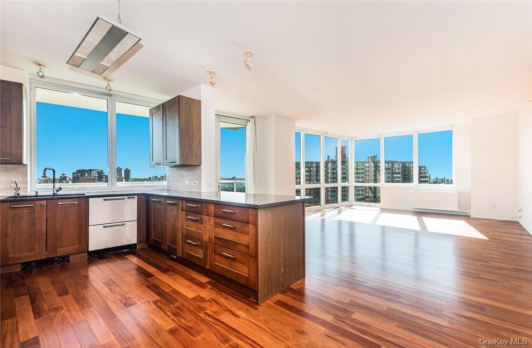 Kitchen featuring dark hardwood / wood-style floors, backsplash, and floor to ceiling windows