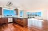 Kitchen featuring dark hardwood / wood-style floors, backsplash, and floor to ceiling windows