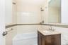 Bathroom featuring vanity, tile walls, tiled shower / bath, and backsplash