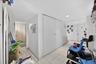 Corridor with light tile patterned floors and recessed lighting