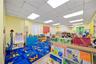 Playroom with a drop ceiling and wood finished floors