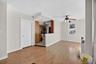 Unfurnished living room with light wood-type flooring and ceiling fan