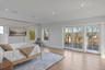 A serene waterfront primary retreat offering private terrace access, expansive views and a tranquil ambiance