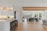 A light filled great room with walls of glass framing sweeping water views