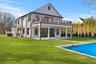 Back of house featuring a patio, a yard, and an outdoor pool