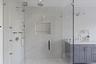 Well appointed primary bathroom with premium fixtures and elevated finishes
