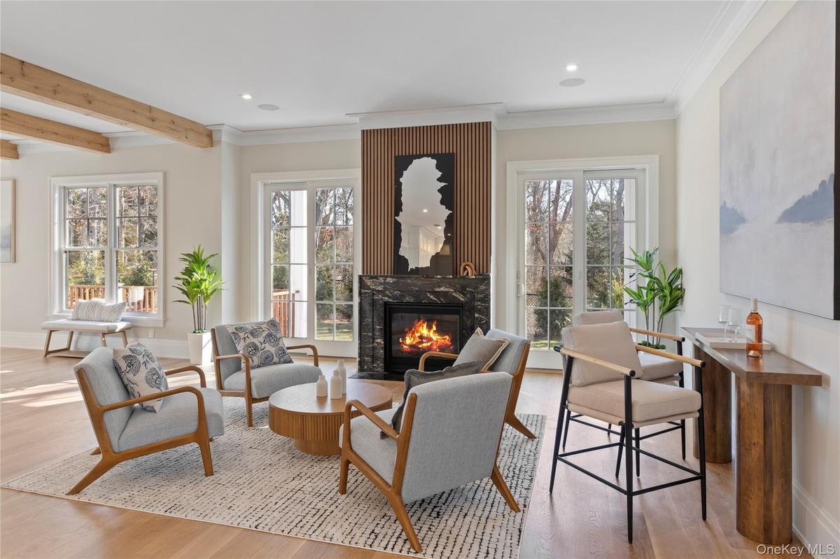 Anchored by a Heat & Glo propane fireplace, the living space is designed for both relaxed everyday living and elegant entertaining with plenty of natu