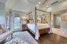 Primary suite feature soaring cathedral ceilings and private balcony