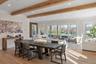Seamless indoor-outdoor flow connects the great room, kitchen, and dining spaces, creating an airy light-filled environment