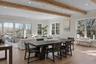 Expansive open-concept living with dramatic ceiling height, refined finishes and tranquil water vistas