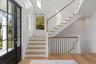 An impressive foyer with clean architectural lines and natural light creates a memorable first impression