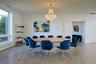 Dining space featuring plenty of natural light, a chandelier, finished concrete flooring, and baseboard heating
