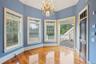 Unfurnished dining area with wood finished floors and a chandelier