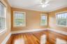 Unfurnished room with crown molding, wood finished floors, and ceiling fan