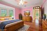Bedroom with crown molding, light wood finished floors, and a ceiling fan