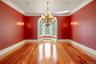 Unfurnished dining area with light wood finished floors, a chandelier, and ornamental molding