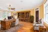Office area featuring ornamental molding, light wood-style floors, and ceiling fan