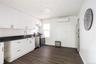 Kitchen with white cabinets, stainless steel appliances, dark wood-style floors, and a wall mounted air conditioner