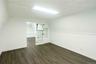 Unfurnished room featuring dark wood-style floors and lofted ceiling