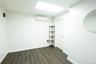 Spare room featuring dark wood-type flooring and a wall mounted air conditioner