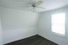 Spare room with dark wood finished floors and ceiling fan