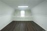 Additional living space featuring built in shelves and dark wood-style floors