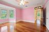 Spare room with ornamental molding, light wood-style flooring, and ceiling fan