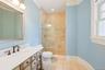 Bathroom with light tile patterned floors, vanity, a stall shower, and recessed lighting