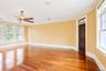 Empty room featuring ornamental molding, light wood-style floors, and a ceiling fan