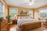 Bedroom with crown molding, wood finished floors, and a ceiling fan