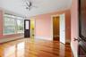 Unfurnished bedroom featuring crown molding, light wood-style floors, a ceiling fan, and connected bathroom